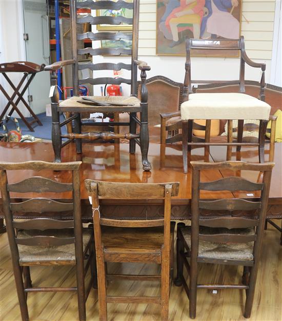 An early 19th Century elm ladderback rush-seat elbow chair, 5 similar dining chairs, a Regency mahogany elbow chair and an elm-seat cha